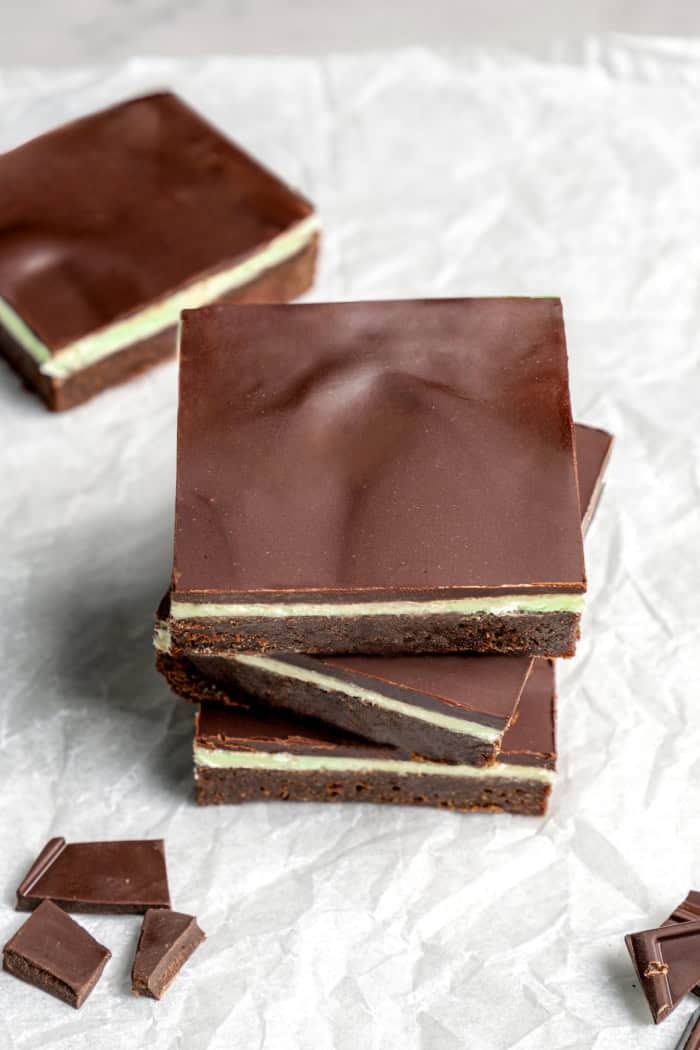 Stack of 3 mint chocolate brownies on parchment paper