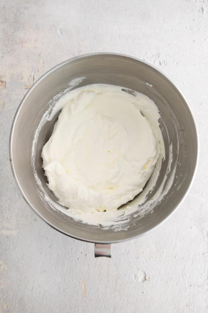 Whipped cheesecake mixture in a large mixing bowl.