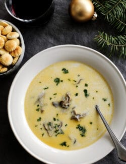 Oyster stew in a white bowl with a silver spoon
