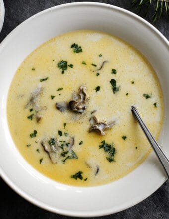 Overhead view of oyster stew in a white bowl