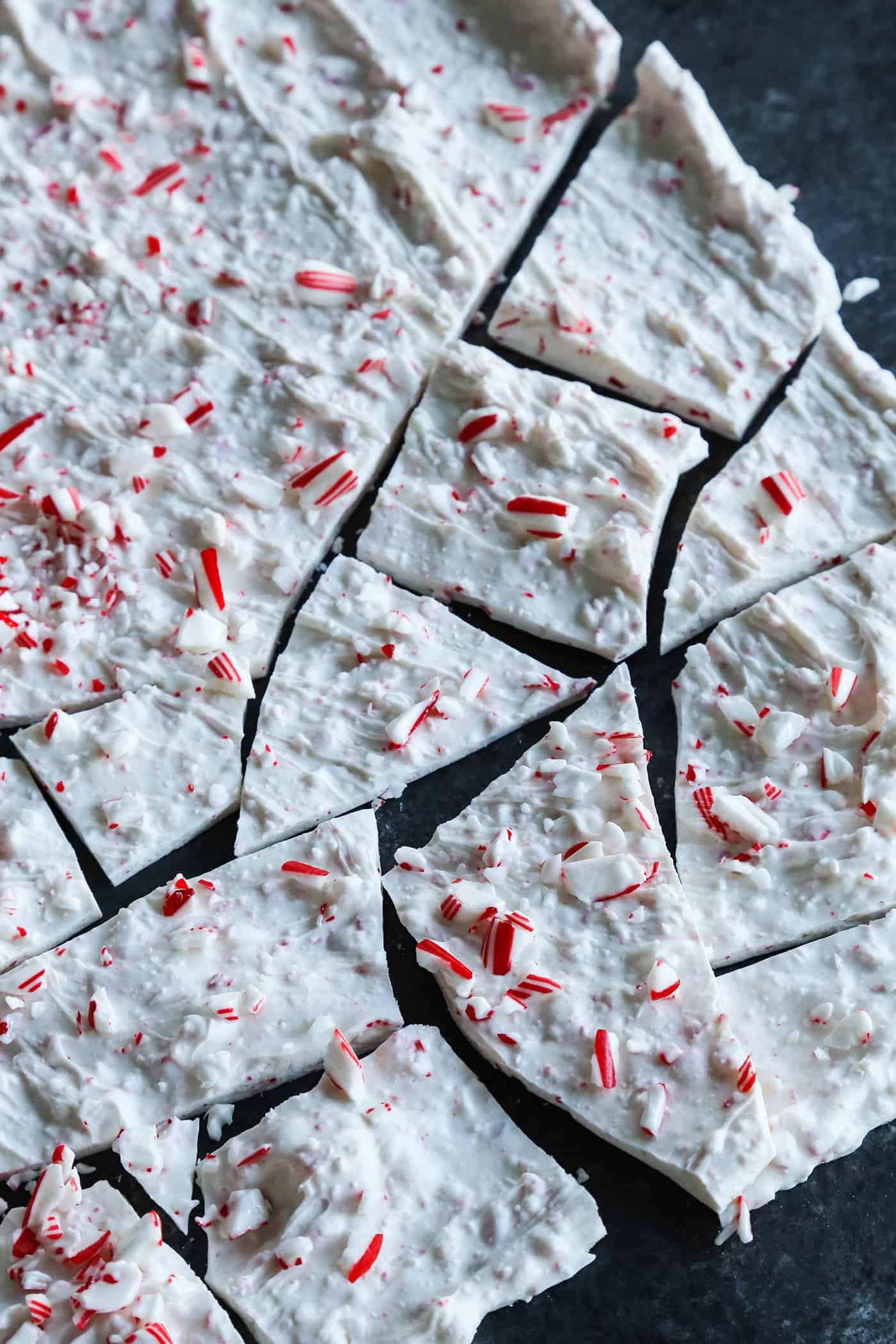 Creamy, minty peppermint bark is easy to make for the holidays with only 3 ingredients! This Christmas candy bark makes a great edible gift. Overhead view of cracked candy cane bark
