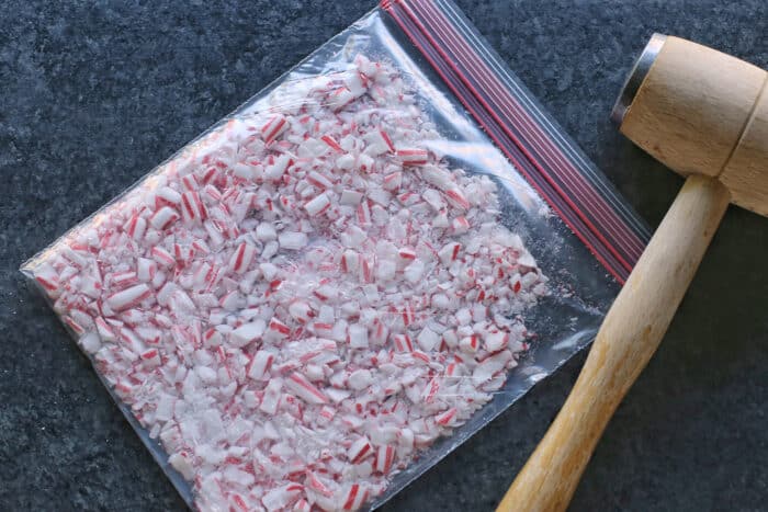 Creamy, minty peppermint bark is easy to make for the holidays with only 3 ingredients! This Christmas candy bark makes a great edible gift. Crushed candy canes in a ziploc bag