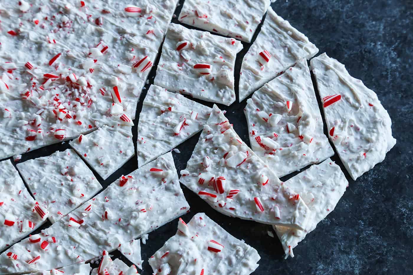 Creamy, minty peppermint bark is easy to make for the holidays with only 3 ingredients! This Christmas candy bark makes a great edible gift. Homemade peppermint bark broken into pieces.