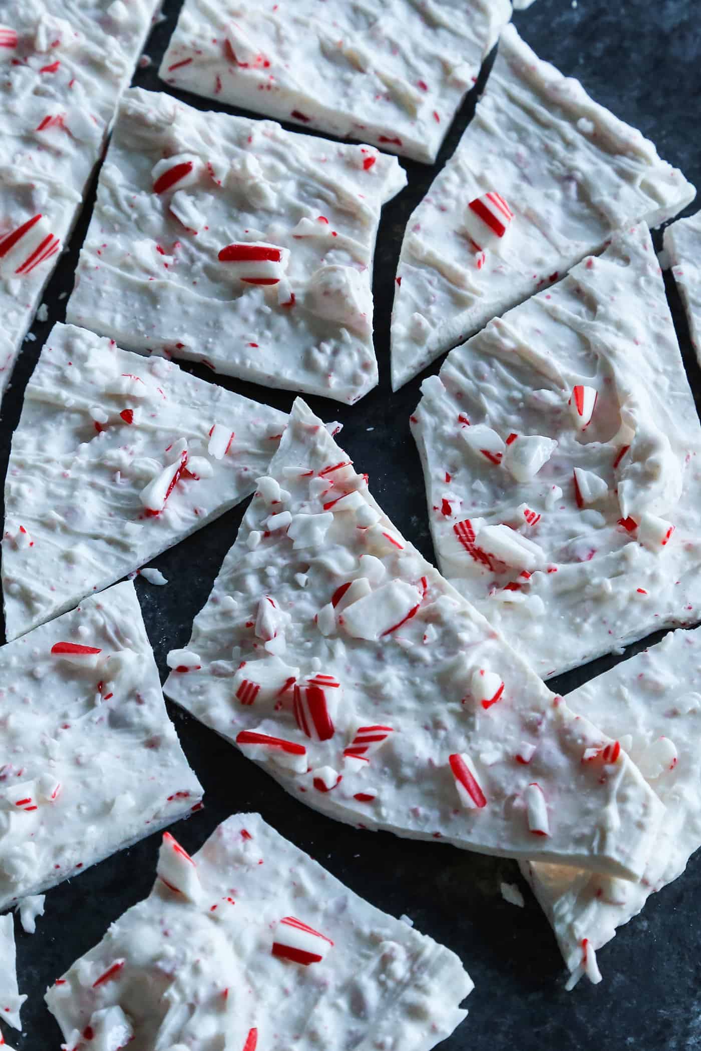 Creamy, minty peppermint bark is easy to make for the holidays with only 3 ingredients! This Christmas candy bark makes a great edible gift. Overhead view of a sheet of peppermint bark broken into pieces.