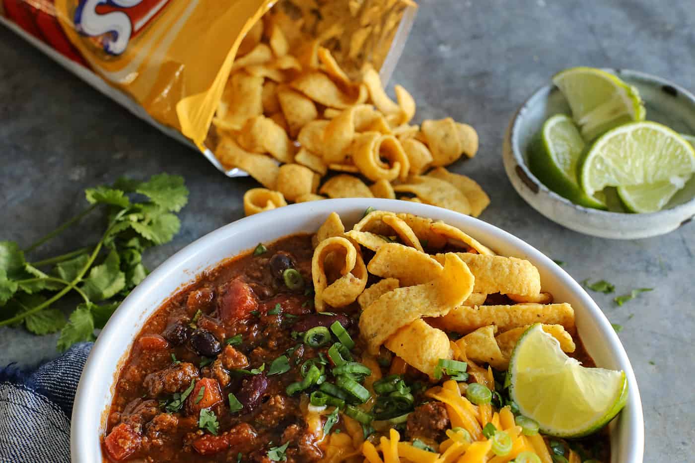 This Slow Cooker Chili recipe has been in my family for years! It's an easy, homemade chili cooked in the crockpot & packed with flavor. A bowl of beef chili topped with Fritos