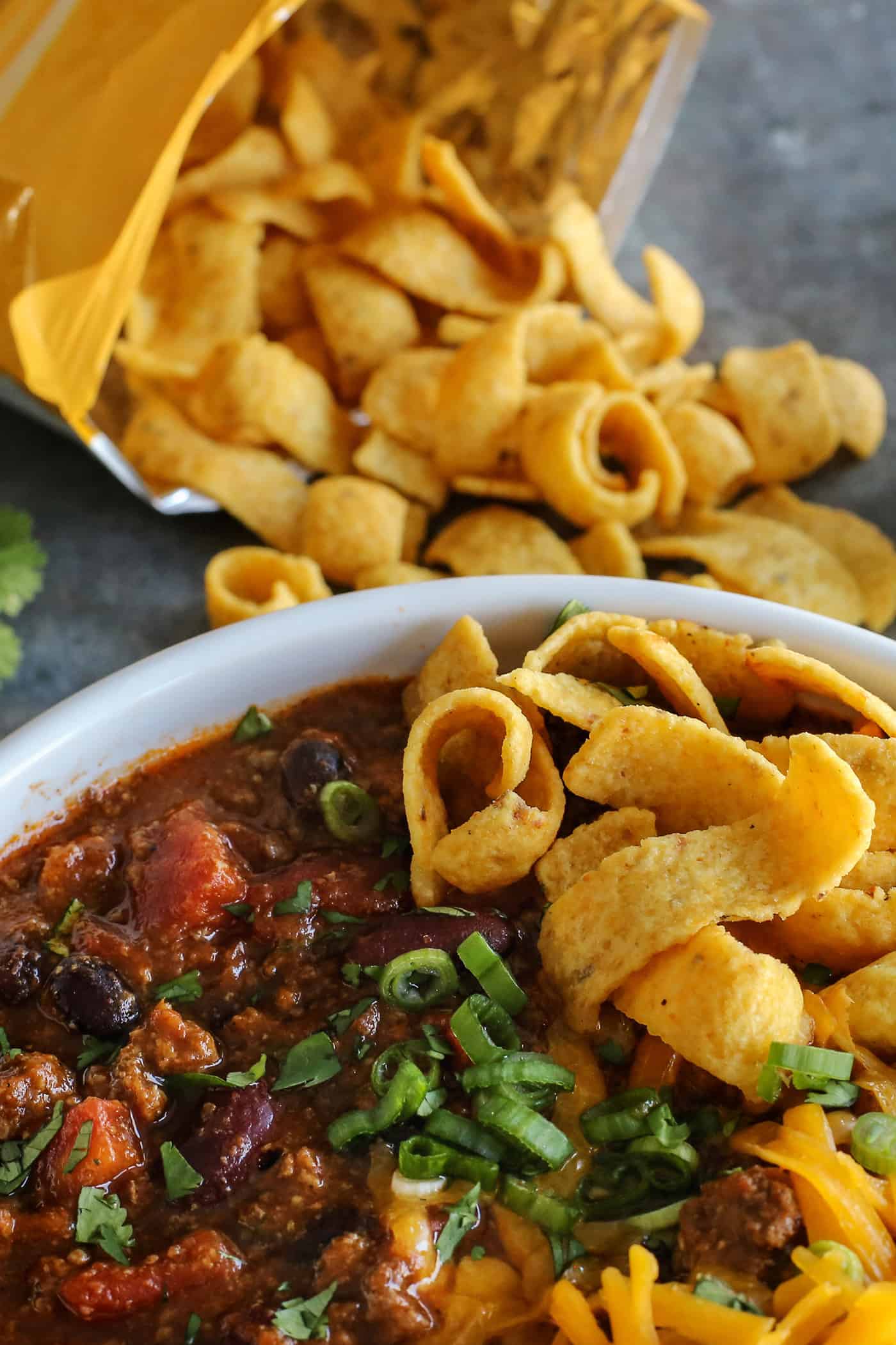 This Slow Cooker Chili recipe has been in my family for years! It's an easy, homemade chili cooked in the crockpot & packed with flavor. Overhead view of a bowl of slow cooker chili