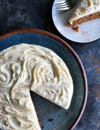 Carrot Cake with cream cheese frosting on a blue platter