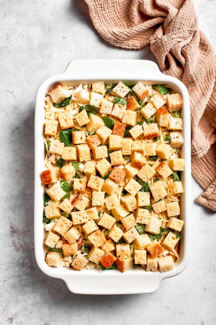 Overhead view of overnight egg bake in casserole dish before baking