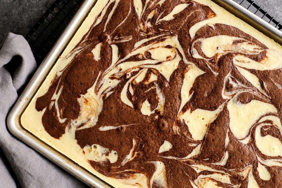 This Easy Marble Cake Recipe features a moist chocolate and vanilla sheet cake slathered with a rich & creamy chocolate buttercream frosting. baked marble cake without frosting