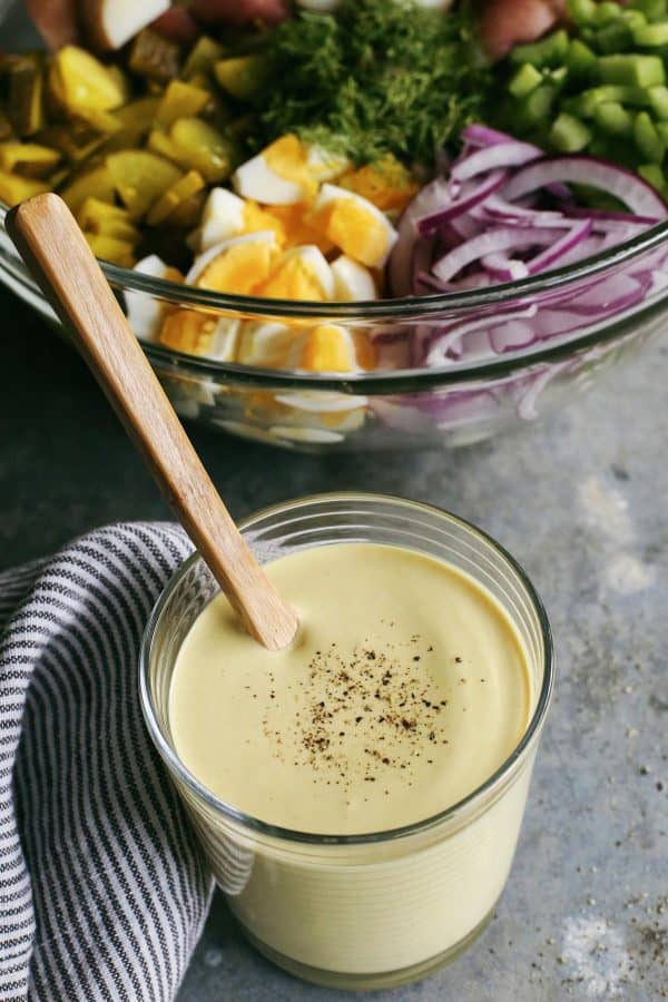 Mustard salad dressing in a glass.