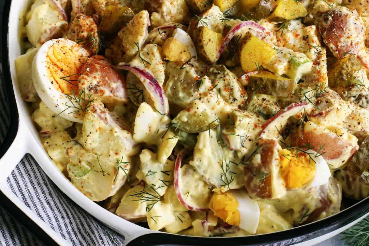 Potato salad with dill pickles and eggs.