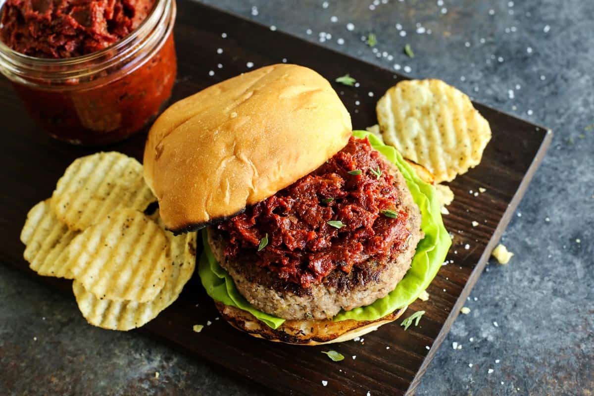Ground Turkey Burgers feature juicy turkey patties stuffed with creamy, tangy goat cheese plus lots of fresh lemon and herbs. A turkey burger with potato chips on the side.