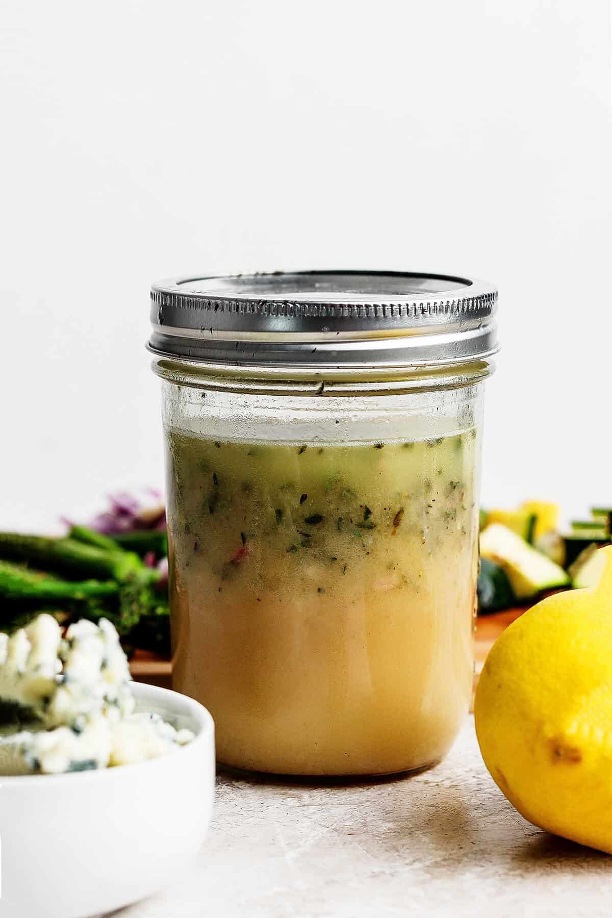 Lemon vinaigrette with fresh herbs in jar