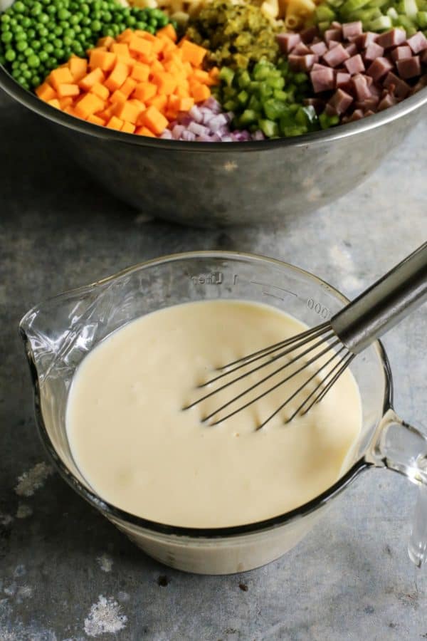 Whisking the creamy mayo dressing. 