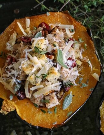 halved acorn squash on pan, stuffed with a turkey and dressing mixture