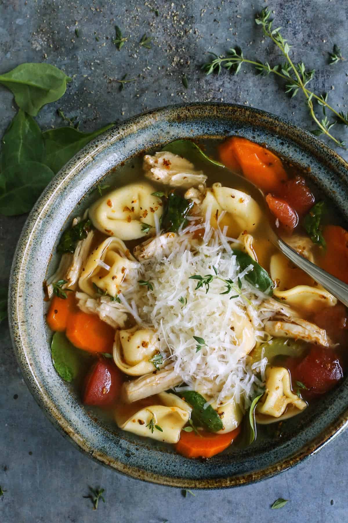 Made with leftover turkey and cheese tortellini, this Italian turkey tortellini soup is full of warm and cozy comfort. Ready in 30 minutes! bowl of tortellini soup with turkey and vegetables