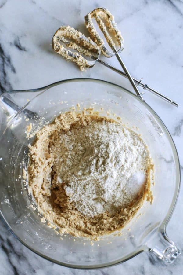 An easy edible cookie dough recipe that's egg-free and made with heat-treated flour so it's safe to eat. Refrigerate or freeze it for later! butter, brown sugar, and granulated sugar in a clear bowl