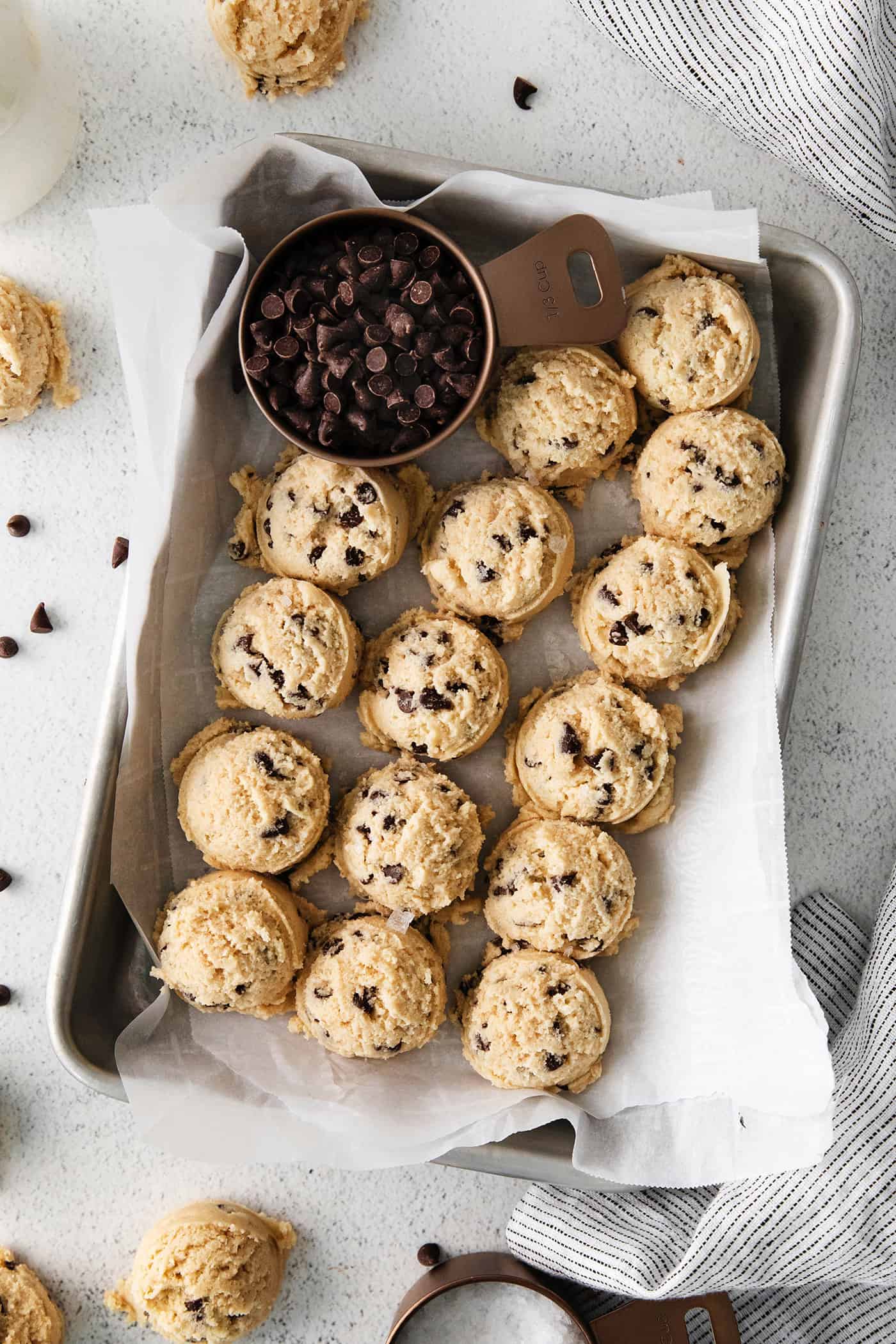 An easy edible cookie dough recipe that's egg-free and made with heat-treated flour so it's safe to eat. Refrigerate or freeze it for later! Overhead view of scoops of edible chocolate chip cookie dough on a tray