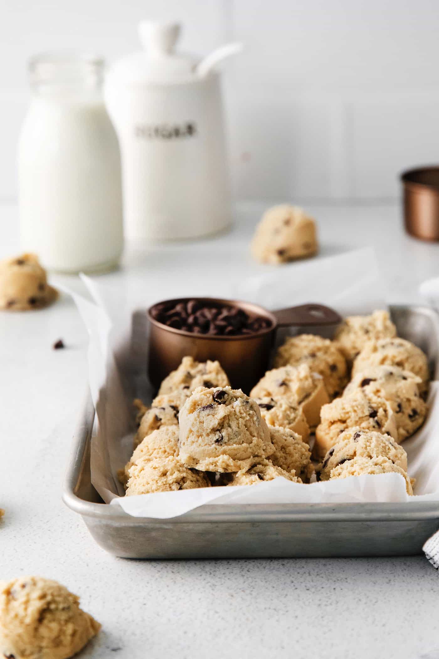 An easy edible cookie dough recipe that's egg-free and made with heat-treated flour so it's safe to eat. Refrigerate or freeze it for later! Edible chocolate chip cookie dough on a baking sheet