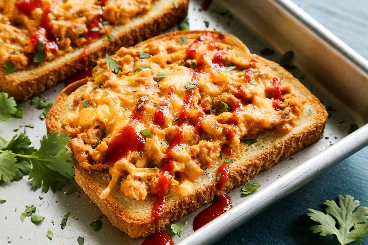 This spicy tuna melt recipe is a quick, easy hot sandwich with tuna, melty cheese, and spicy sriracha made warm and toasty in the oven! hot tuna sandwich