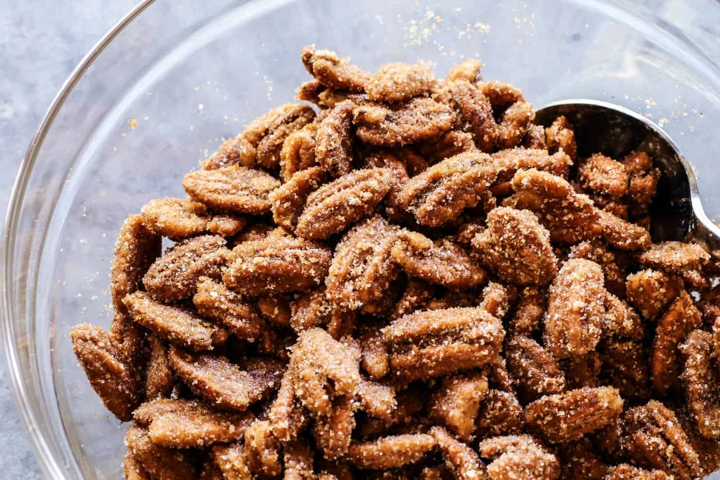 Crunchy candied pecans recipe for a sweet and salty treat with just a hint of heat. The perfect snack, salad topper, or edible gift! pecans coated with sugar mixture