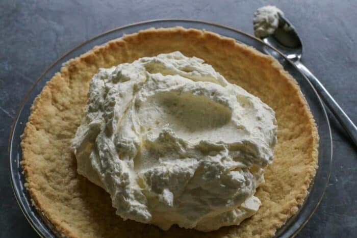This Strawberry Cream Cheese Pie piles a fluffy cream cheese layer on a crisp shortbread cookie crust along with a fresh strawberry topping. The cream cheese mixture is added to the center of the baked pie crust