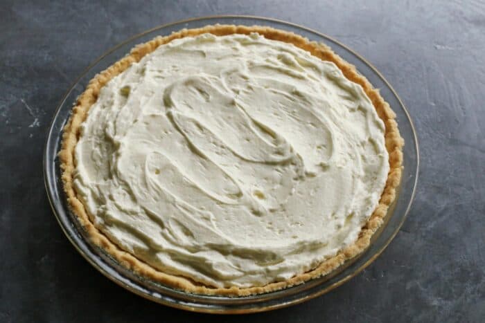 This Strawberry Cream Cheese Pie piles a fluffy cream cheese layer on a crisp shortbread cookie crust along with a fresh strawberry topping. The cream cheese layer is spread evenly into the baked pie crust