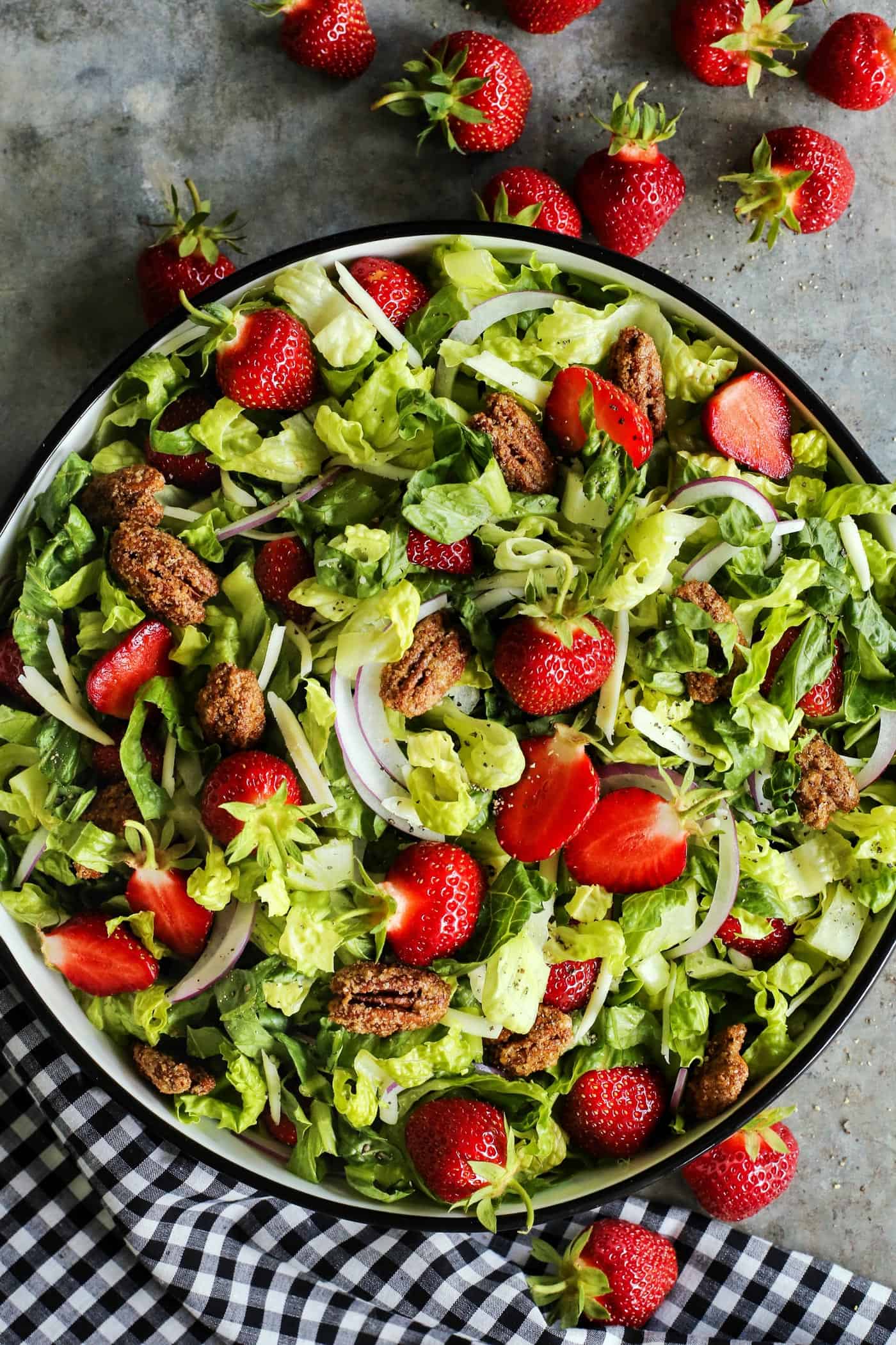 This strawberry salad with red wine vinaigrette has Monterey Jack cheese and ridiculously crunchy candied pecans. It's a crowd-pleaser! strawberry salad with fresh greens and candied pecans