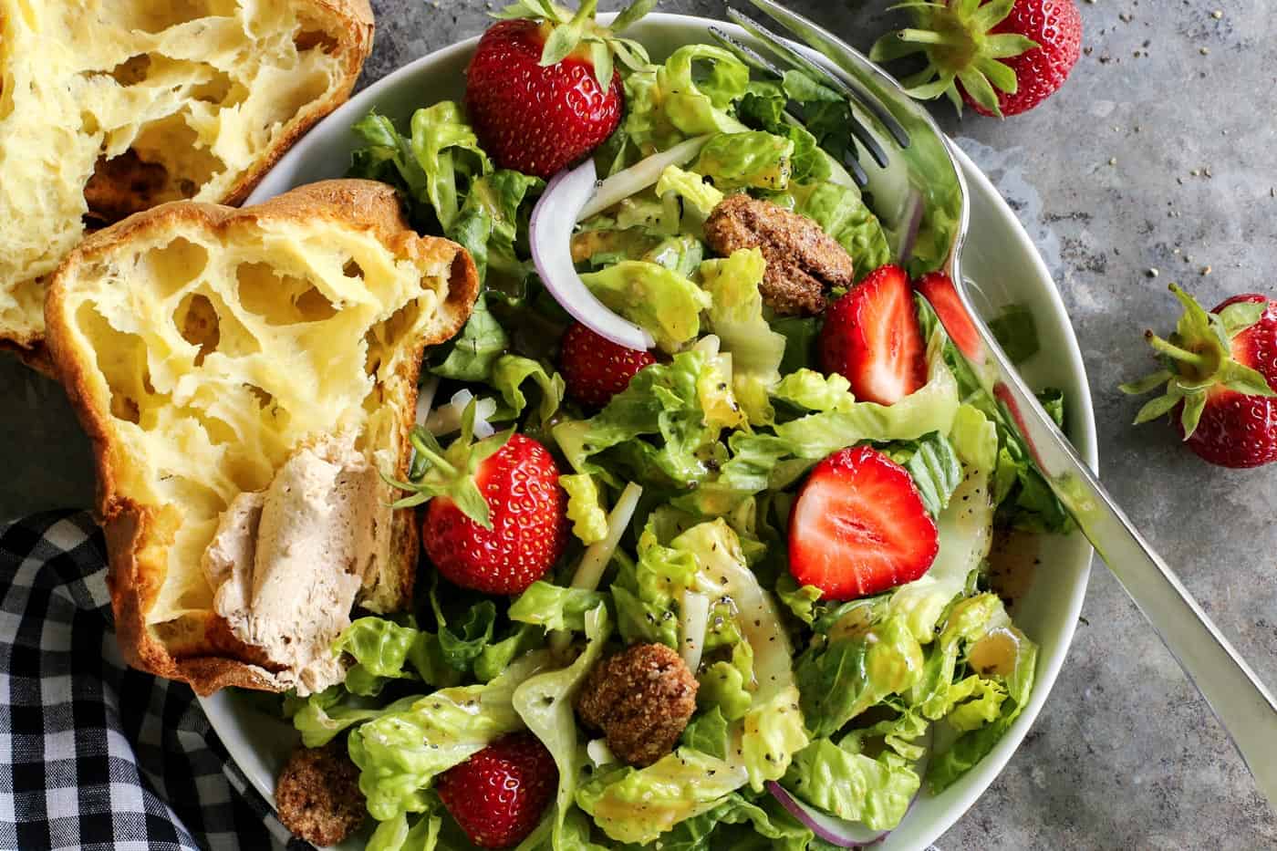 This simple sweet red wine vinaigrette is an easy homemade salad dressing that uses just a few pantry items and takes only 5 minutes to make! Lettuce and strawberry salad on a plate, with a popover