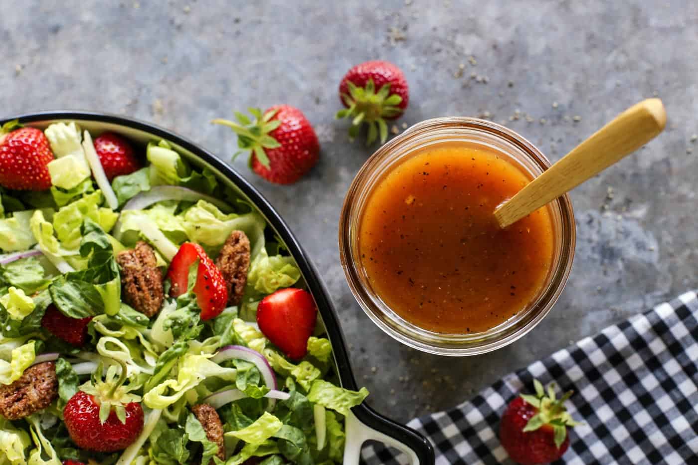 This simple sweet red wine vinaigrette is an easy homemade salad dressing that uses just a few pantry items and takes only 5 minutes to make! Red wine vinaigrette in a jar, by a lettuce and strawberry salad