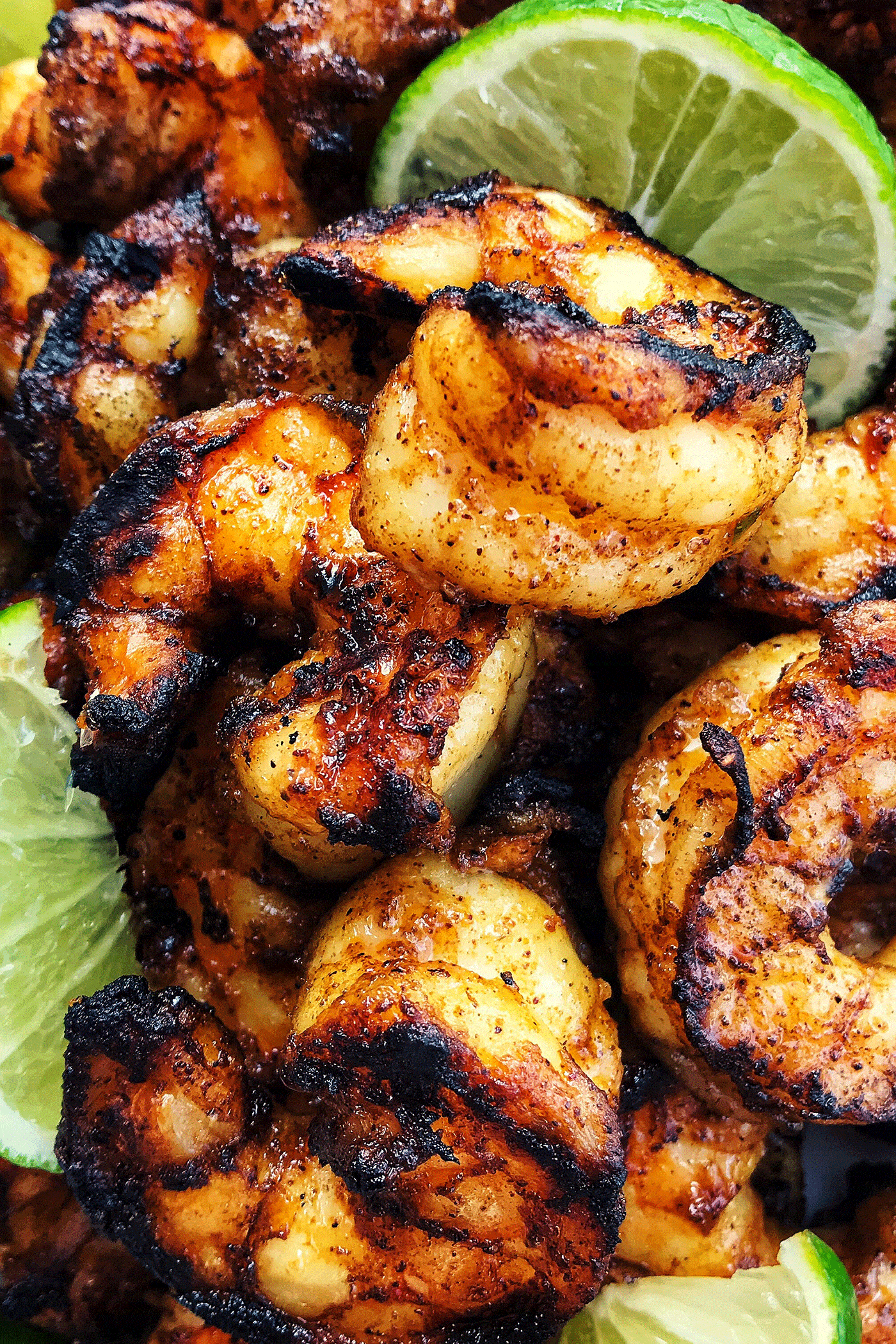 These 18 easy shrimp recipes are simple to make & guaranteed to impress! Learn everything you need to know about shrimp, plus how to cook it. jumbo shrimp that is charred from grill, with fresh lime wedges