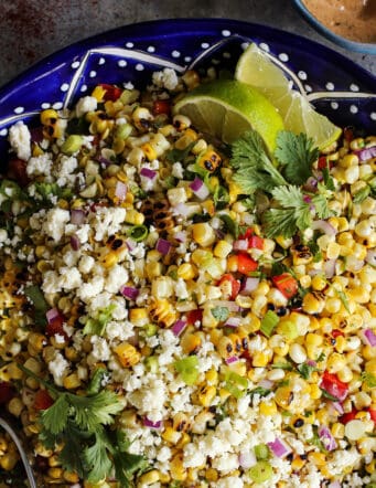 Mexican corn salad in a blue painted pottery bowl
