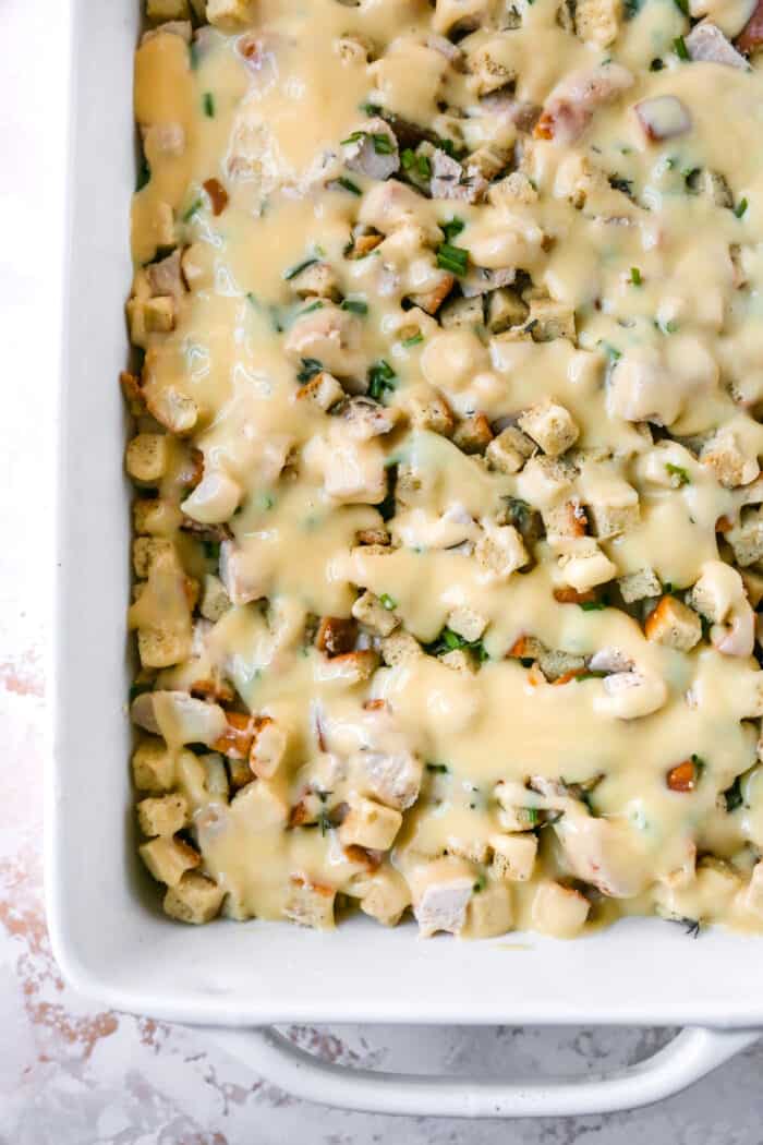 This hearty leftover turkey casserole recipe with sage, thyme, cream of chicken, and crispy stuffing is an easy way to clean out the fridge. Top layer of turkey and stuffing drizzled with the soup mixture.