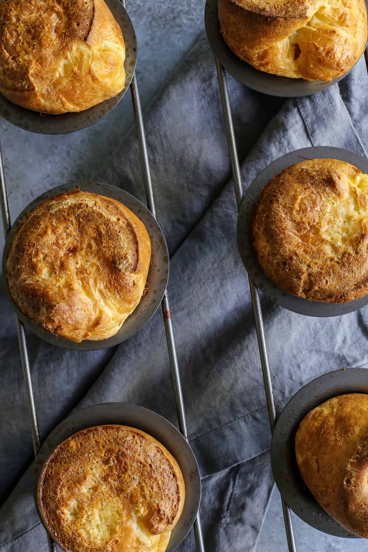 Popovers bake up tall, golden, and airy with crisp edges and soft centers, using only 4 simple ingredients and an easy, foolproof method! Baked popovers in a popover pan.