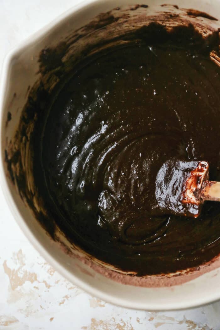Gingerbread brownies are moist and fudgy, with a touch of molasses and warm spices. A fun holiday twist on a traditional brownie recipe! mixing bowl with brownie batter