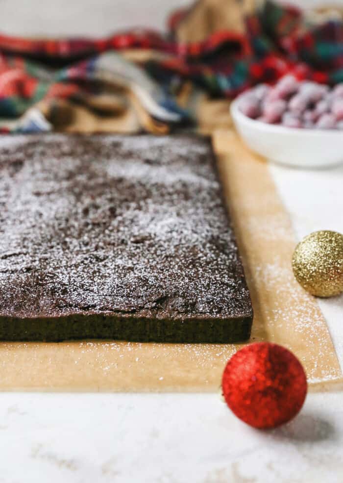 Gingerbread brownies are moist and fudgy, with a touch of molasses and warm spices. A fun holiday twist on a traditional brownie recipe! baked brownie pulled out of pan, for cutting