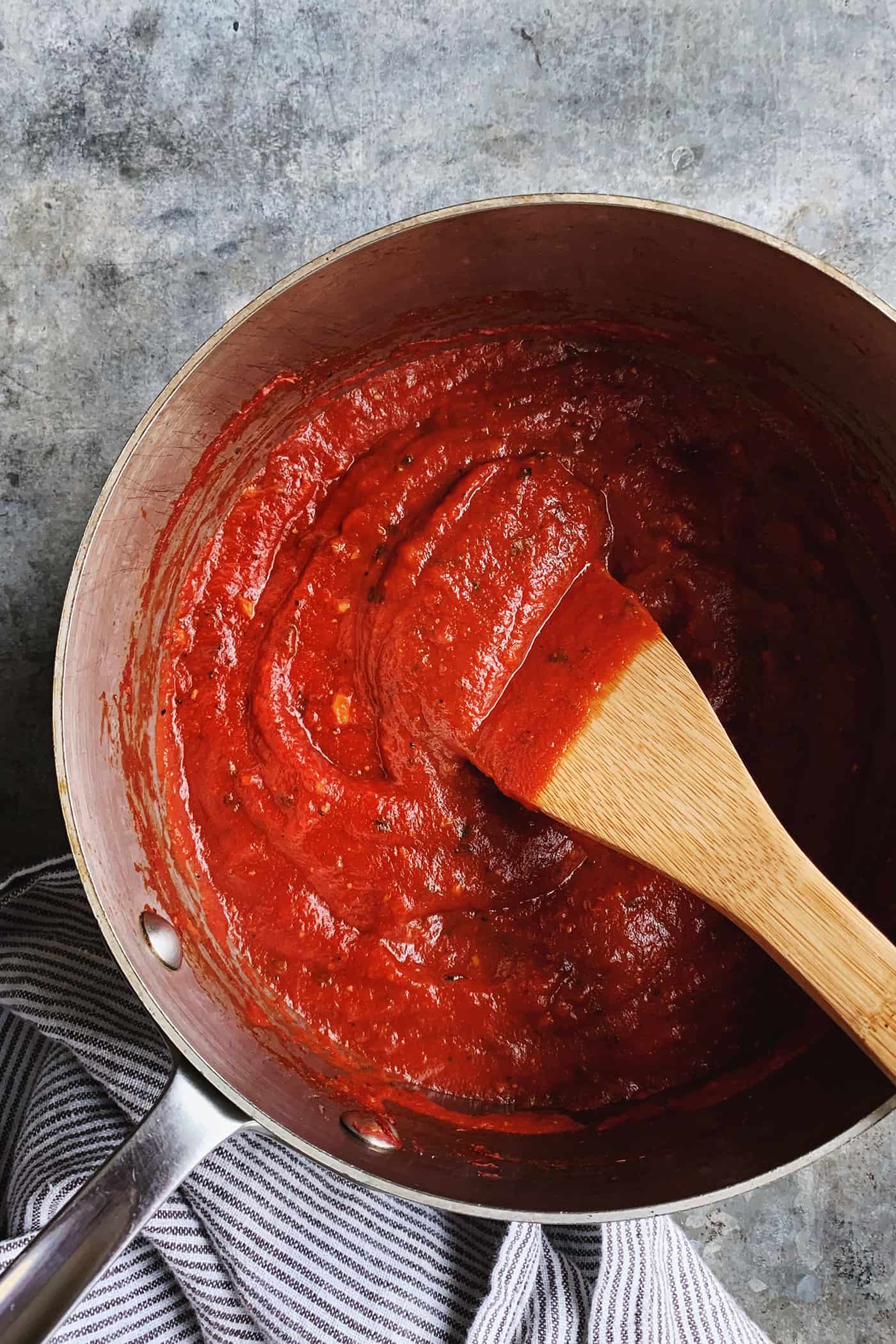 An easy recipe for the best homemade pizza sauce. It's a thick, tasty red sauce with fresh tomato flavor, made from simple ingredients! saucepan of homemade pizza sauce