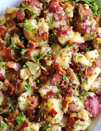 German potato salad with bacon on a white platter