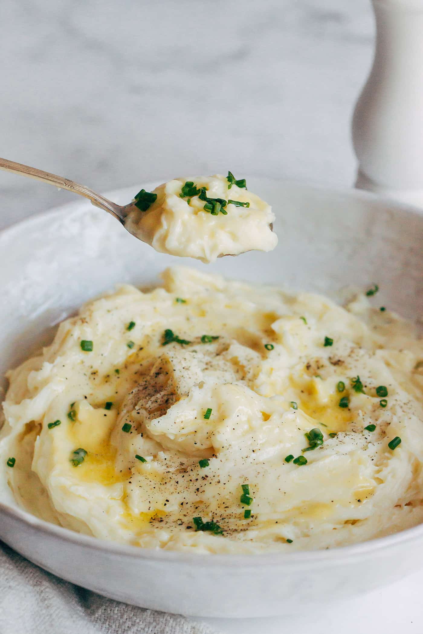Grabbing a spoonful of creamy mashed potatoes from the bowl.