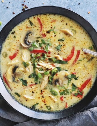 coconut curry chicken soup in a black bowl