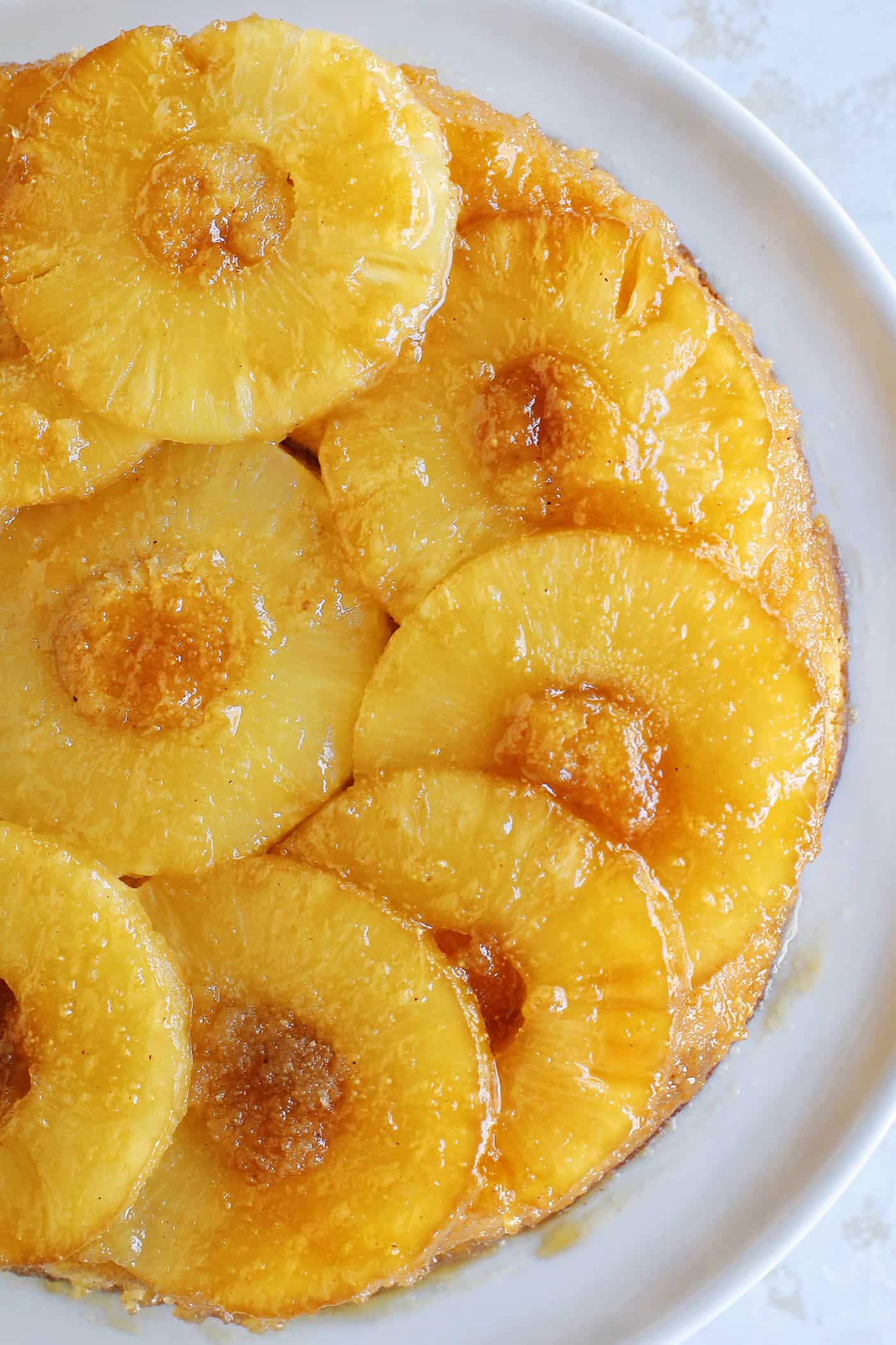 Overhead view of a baked pineapple upside down cake topped with caramelized pineapples.