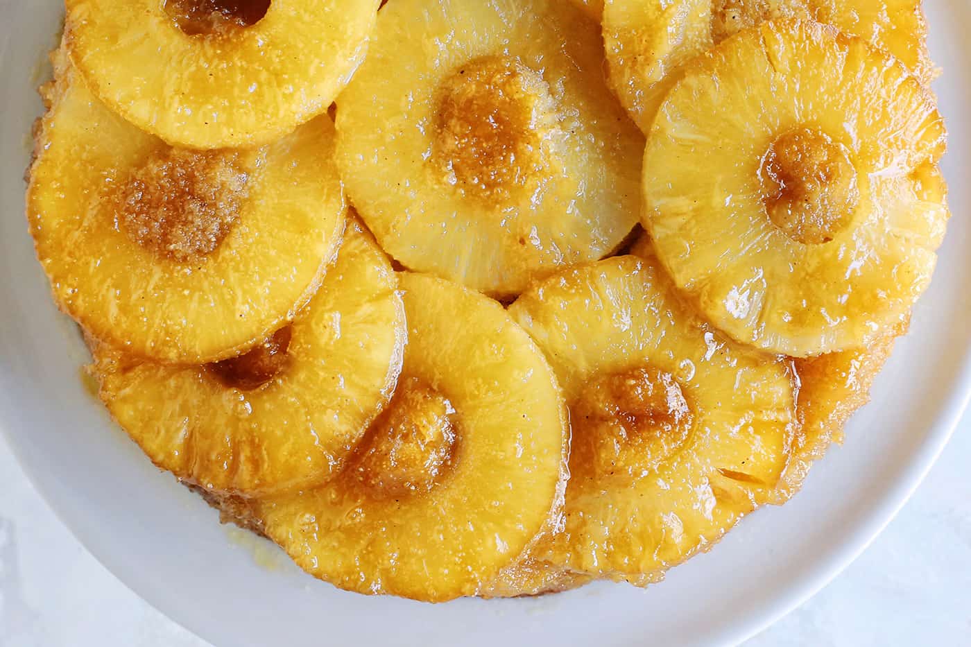 Overhead view of a baked pineapple upside down cake topped with caramelized pineapples.