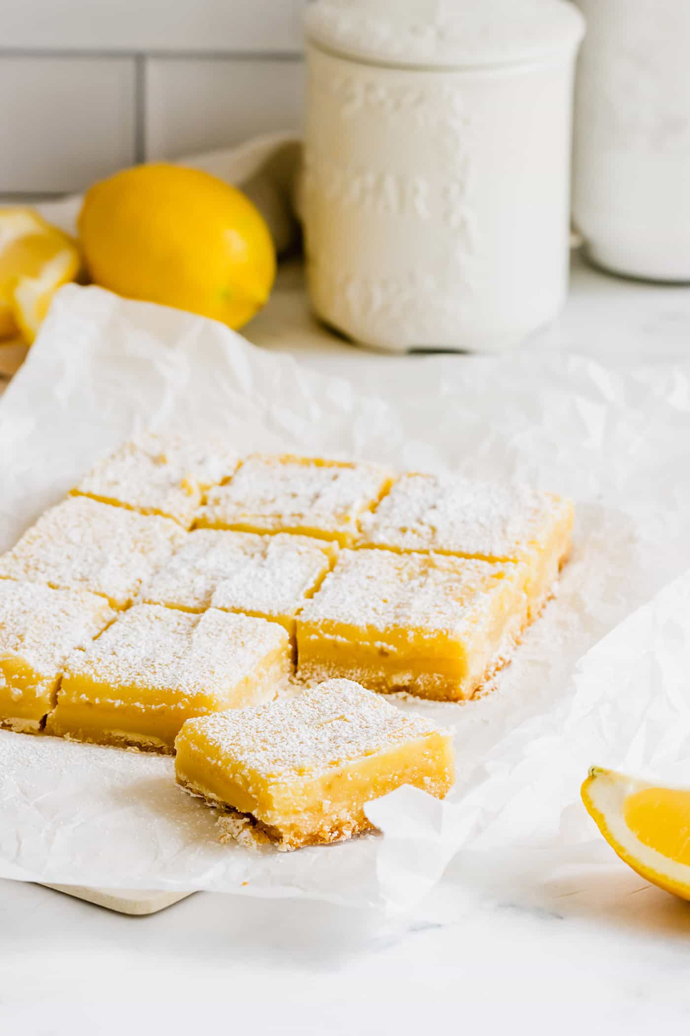 This easy lemon bars recipe is loaded with fresh lemon flavor in a buttery shortbread crust. Only 4 ingredients in the lemon curd filling! bars consisting of a shortbread crust topped with lemon curd and sprinkled with powdered sugar