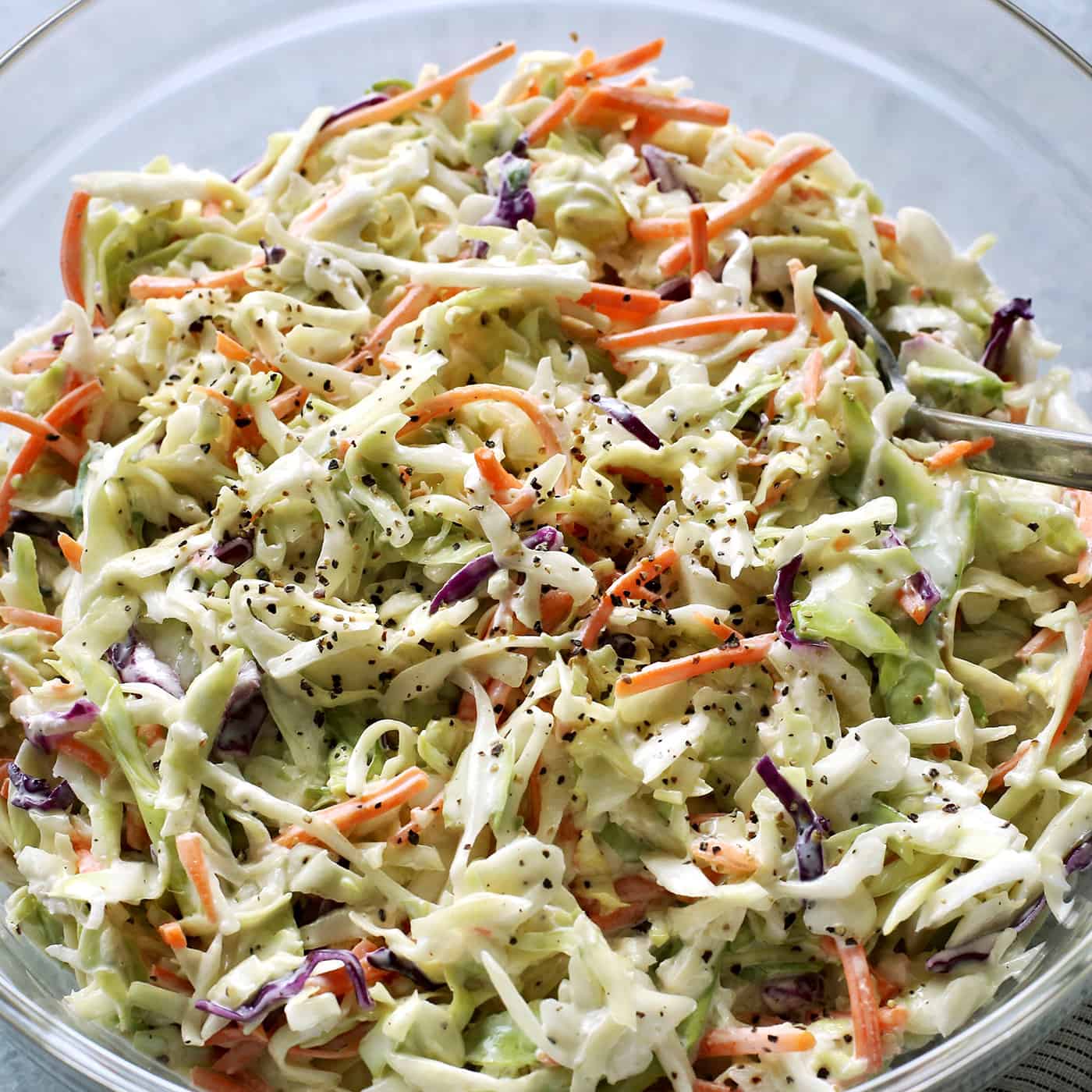 This crunchy, creamy coleslaw recipe is a favorite BBQ side. Serve it as a cooling accompaniment to grilled meats, tacos, or pulled pork! salad of shredded cabbage and carrots with a mayo and sour cream based dressing