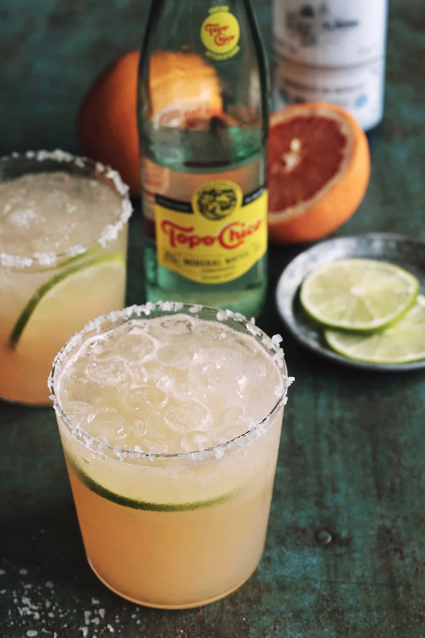 paloma cocktails, fresh grapefruit, and bottles of mineral water and tequila
