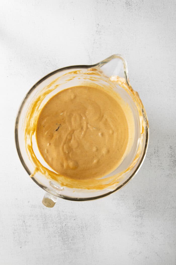 Overhead shot of pumpkin ice cream in glass bowl with spout