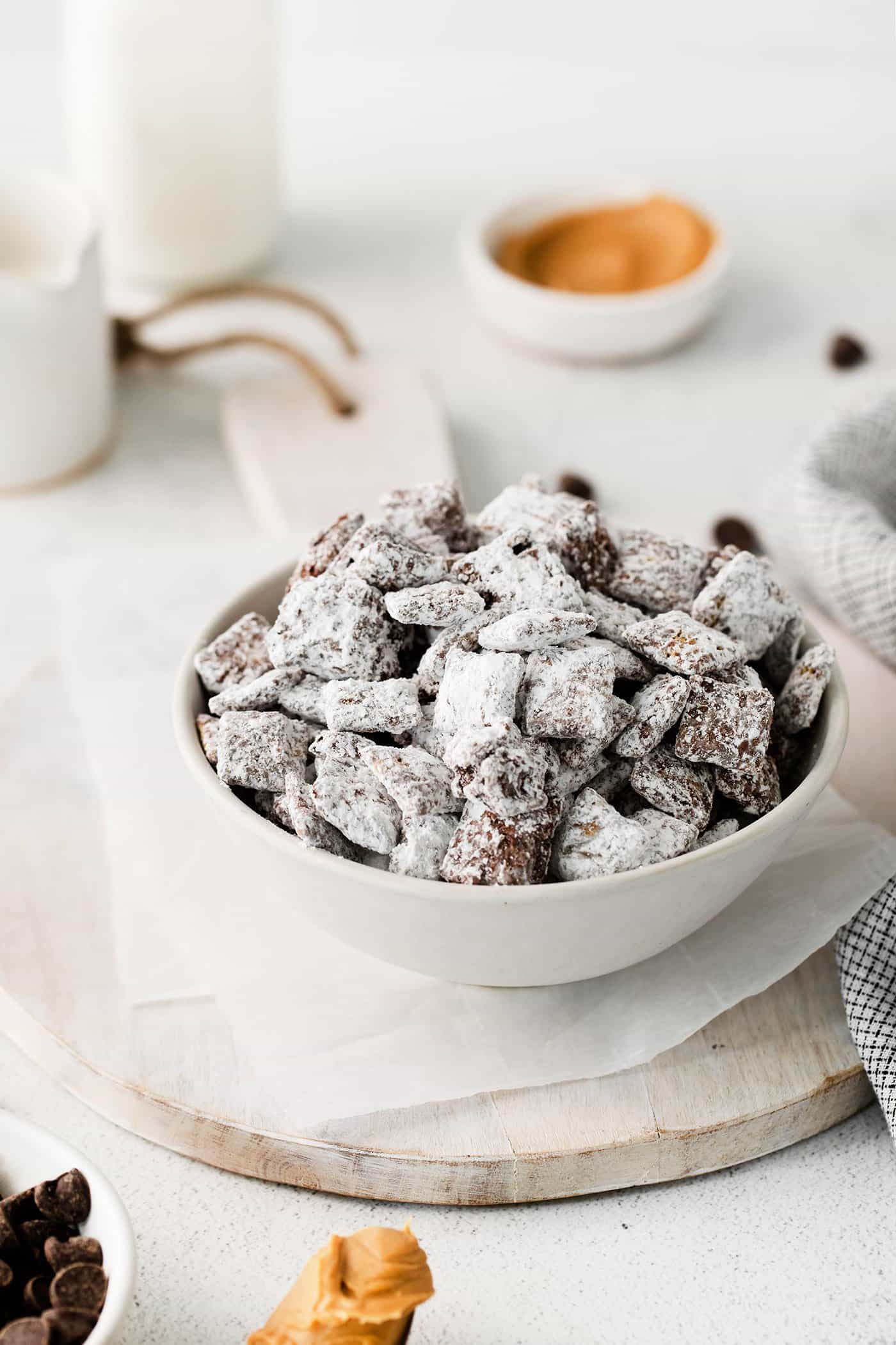 Homemade puppy chow in a white bowl.