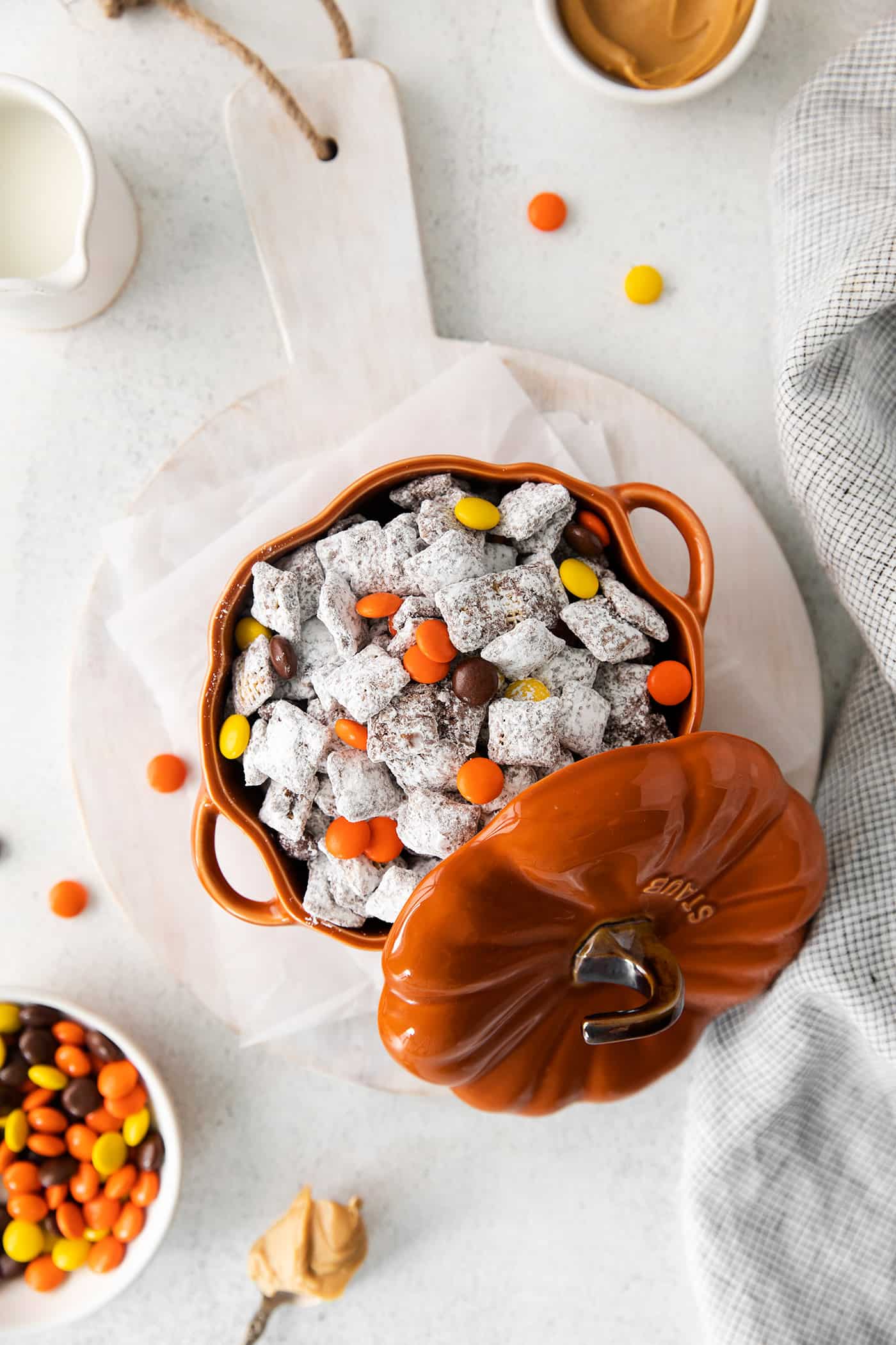 Overhead view of fall-themed puppy chow inside a pumpkin-shaped bowl with a lid.