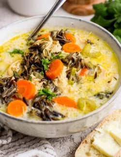 Bowl of creamy chicken wild rice soup with spoon