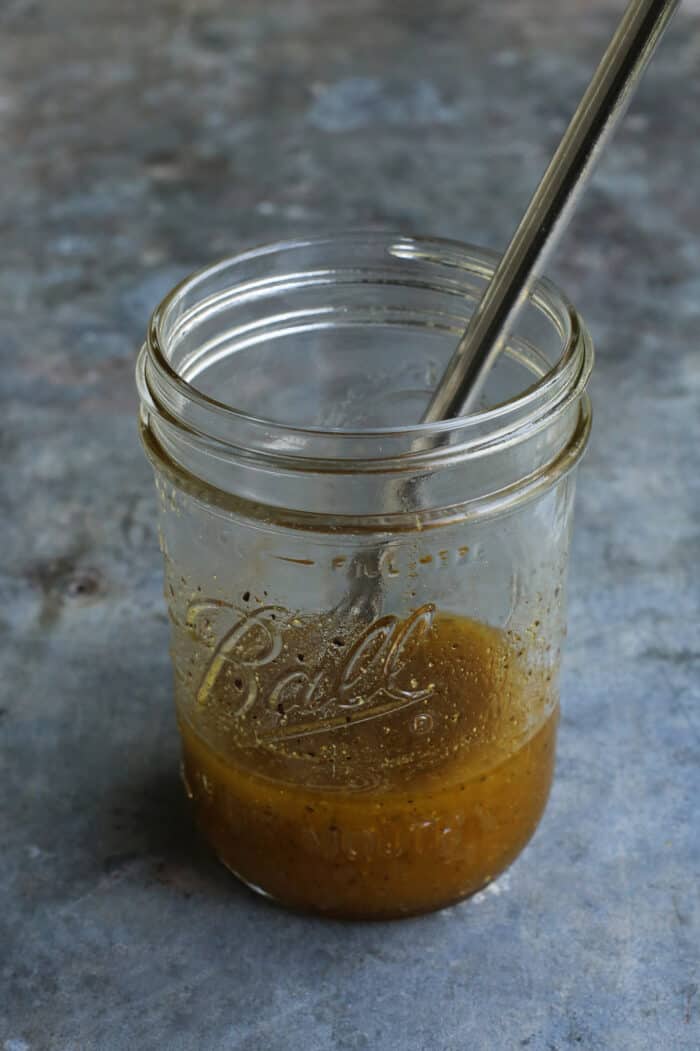 With fresh corn, mangos, tomatoes, and a touch of heat, plus a light and flavorful dressing, this Sweet Corn Salad is a summer treat! salad dressing mixed in a jar